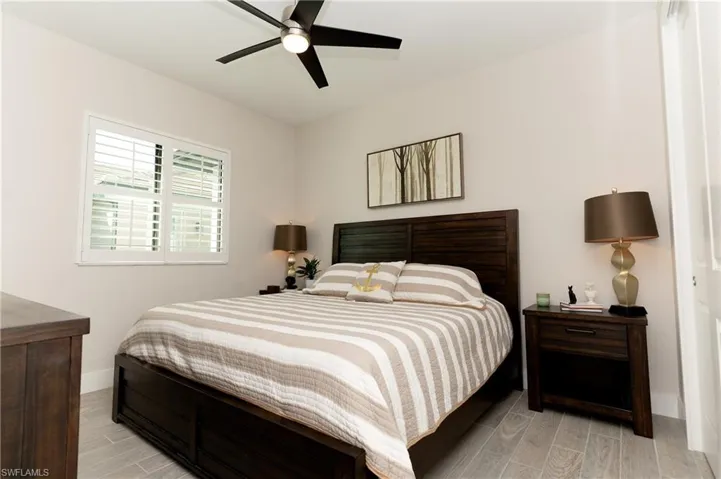 Bedroom with ceiling fan and light hardwood / wood-style flooring