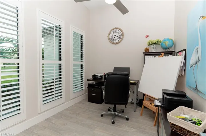 Office space featuring ceiling fan, plenty of natural light, and light hardwood / wood-style flooring