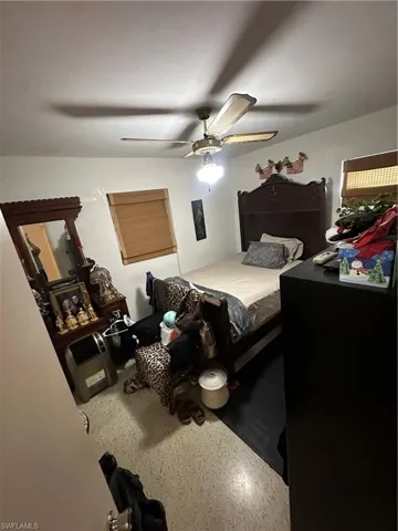 Bedroom featuring a ceiling fan and speckled floor