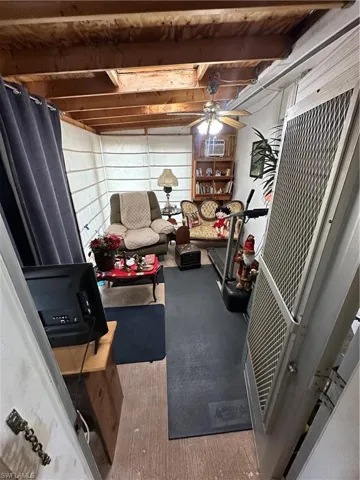 Exercise area with ceiling fan and light carpet