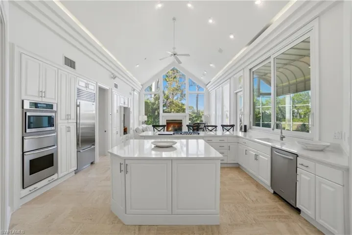 Cathedral Ceilings in this spacious kitchen with windows galore make it most inviting