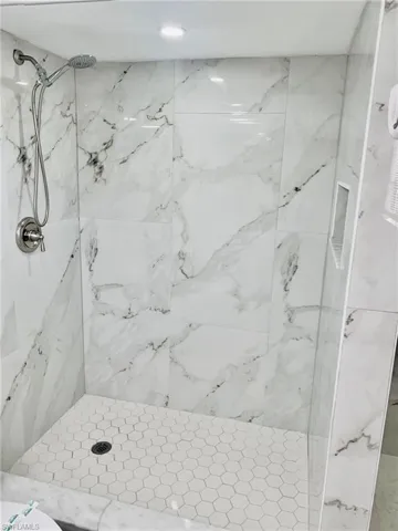 Bathroom with a marble finish shower