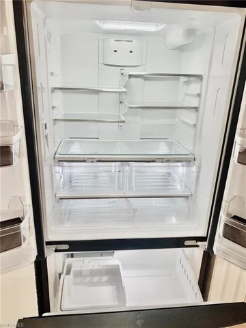Kitchen view of white refrigerator