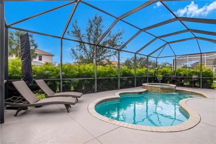 View of pool with a pool with connected hot tub