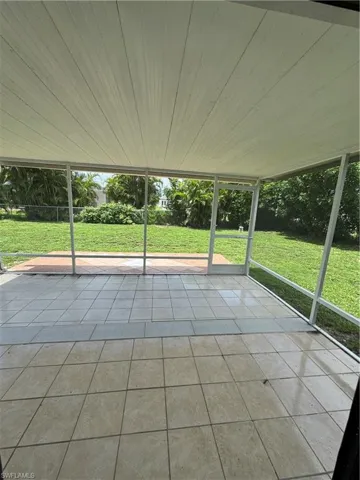 Spare room with dark hardwood / wood-style flooring and ceiling fan
