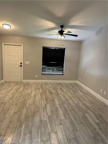 Empty room featuring ceiling fan and hardwood / wood-style floors