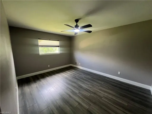 Bathroom featuring toilet, a tile shower, and tile patterned flooring