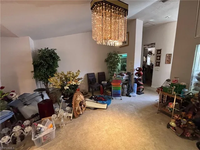 Dining area featuring suspended lighting and carpet flooring