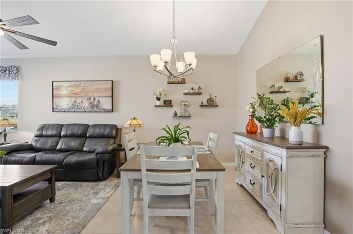 Dining area with light tile patterned floors and a chandelier