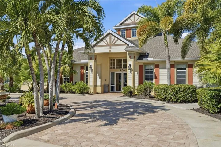 View of front of house featuring roof with shingles, decorative driveway, and french doors
