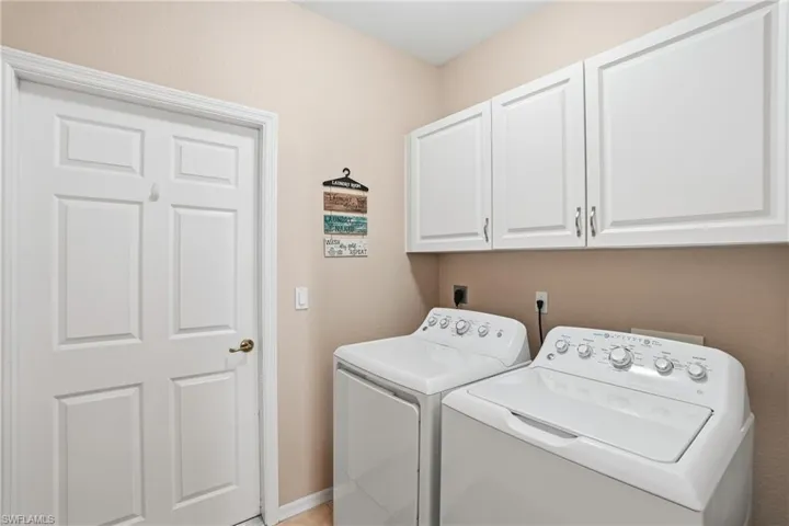 Laundry room with washer and dryer and cabinet space