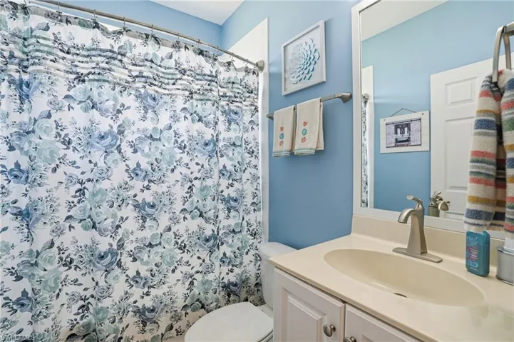 Bathroom with vanity and a shower with shower curtain