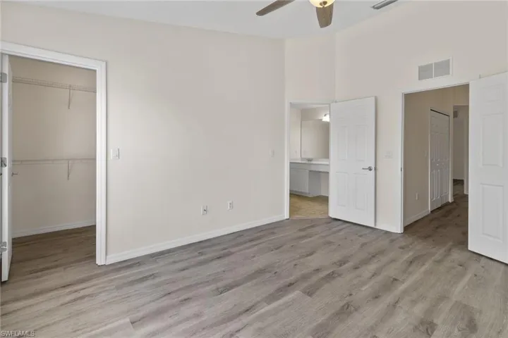 Wood-finish flooring, vaulted ceiling, and ceiling fan