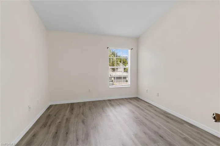 Neutral wall tones with wood-finish flooring