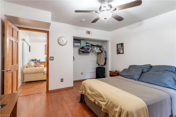Bedroom featuring hardwood / wood-style floors, ceiling fan, and a closet