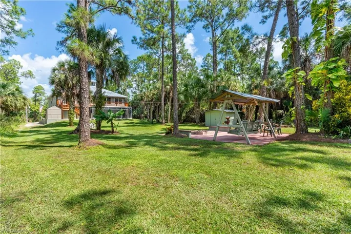 View of yard with a playground and an outdoor structure