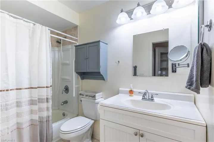 Full bathroom with vanity, toilet, and shower / tub combo with curtain