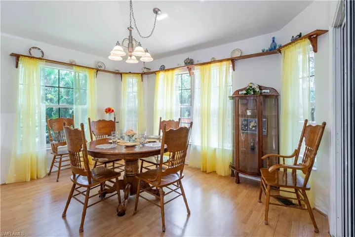 Dining space with an inviting chandelier and light wood-type flooring