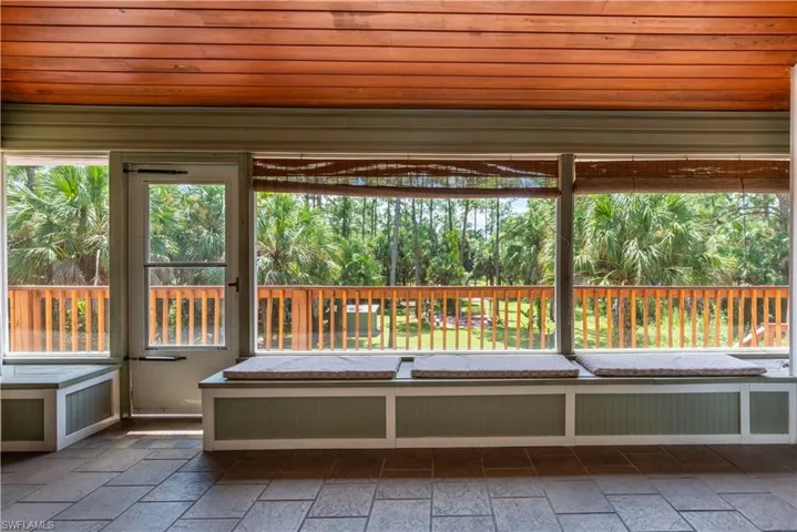 Unfurnished sunroom with wood ceiling