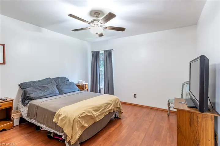 Bedroom with wood-type flooring and ceiling fan