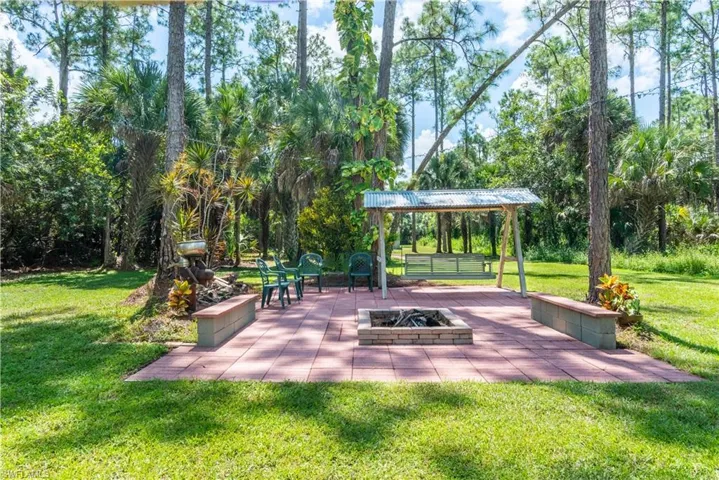 View of home's yard with a fire pit, a lawn, and a patio area