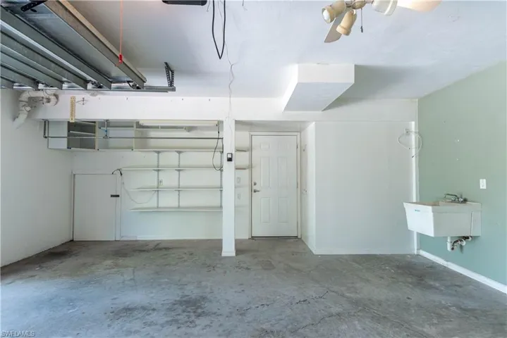 Garage featuring sink and ceiling fan