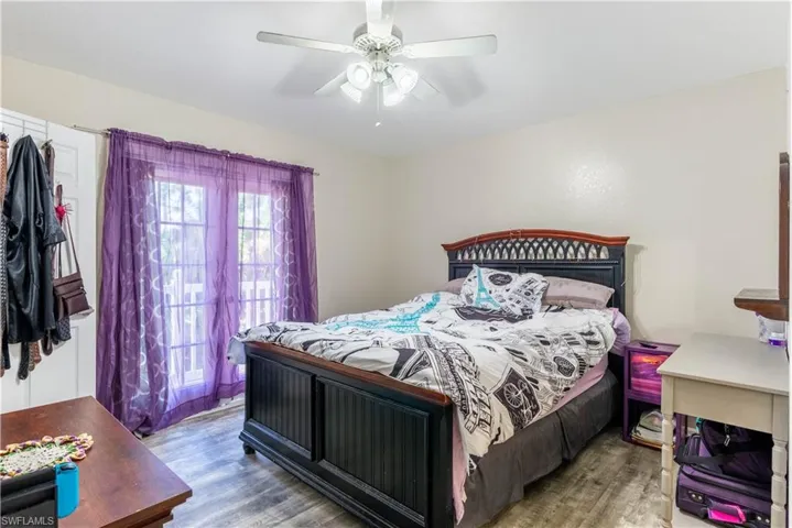 Bedroom with hardwood / wood-style flooring and ceiling fan