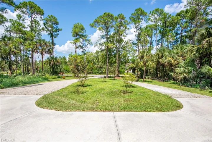 View of home's community with a lawn
