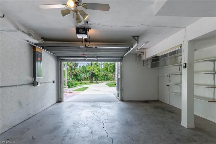 Garage with electric panel and ceiling fan