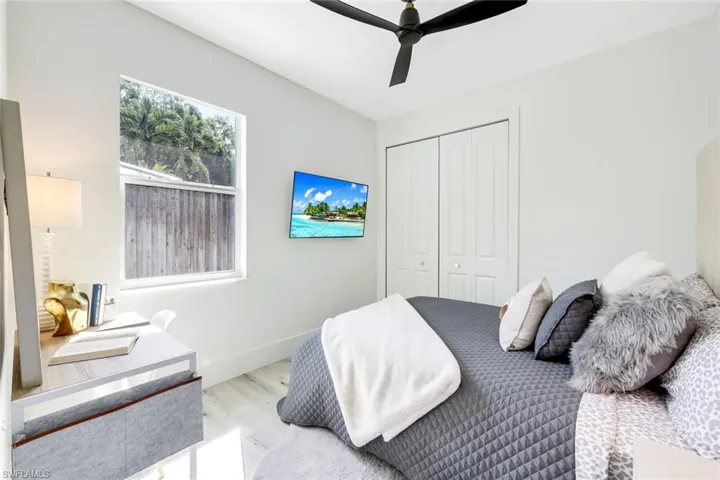 Bedroom featuring ceiling fan, a closet, and hardwood / wood-style floors