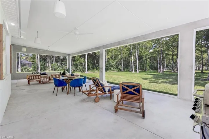 Sunroom / solarium featuring ceiling fan