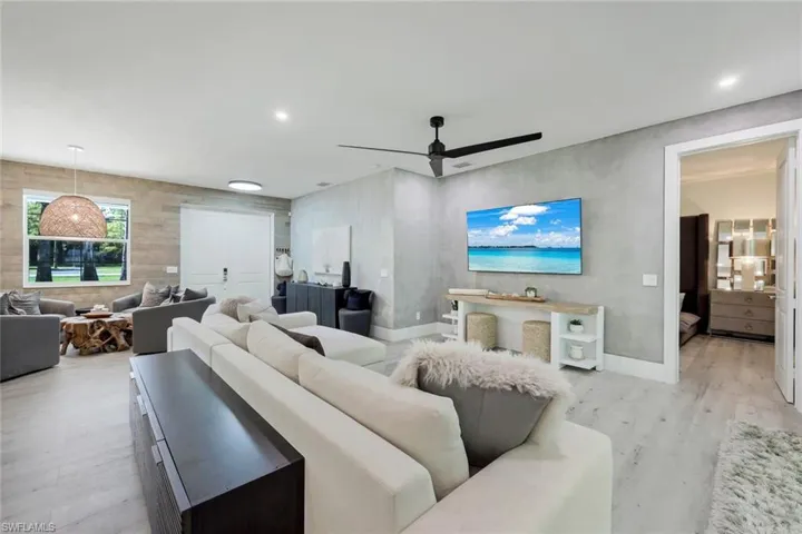 Living room featuring ceiling fan and light hardwood / wood-style flooring