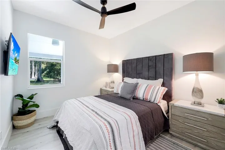 Bedroom with ceiling fan and light hardwood / wood-style floors