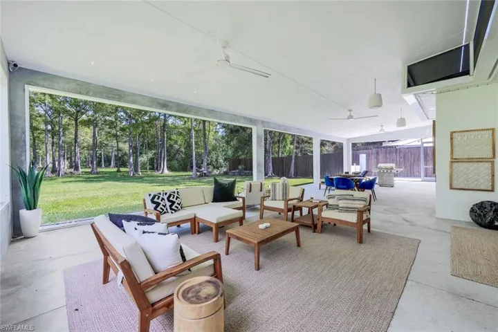 Sunroom with a wealth of natural light and ceiling fan