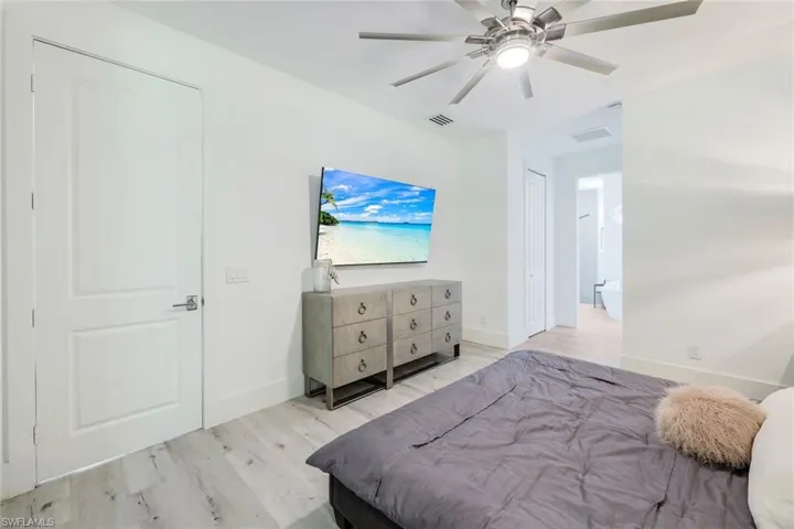 Bedroom with ceiling fan and light hardwood / wood-style flooring