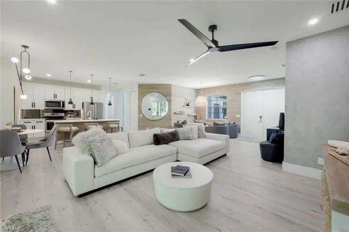 Living room with light wood-type flooring and ceiling fan