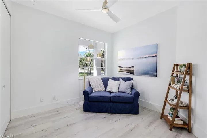 Sitting room featuring ceiling fan and light hardwood / wood-style floors