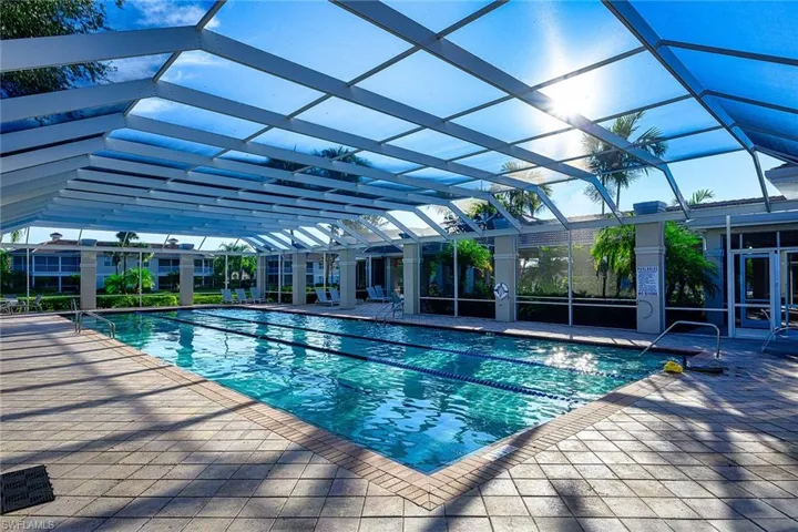 View of swimming pool featuring a lanai and a patio