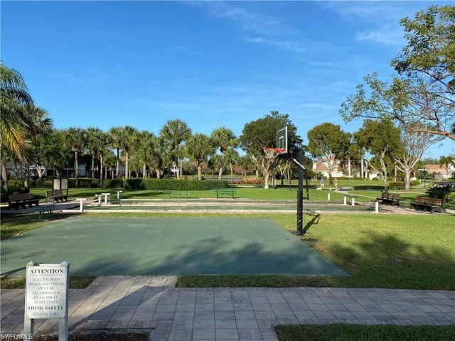 View of home's community with a yard and basketball court