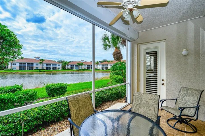 Sunroom featuring a water view and ceiling fan