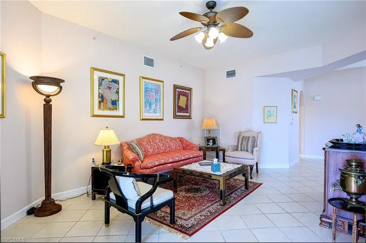 Tiled living room featuring ceiling fan