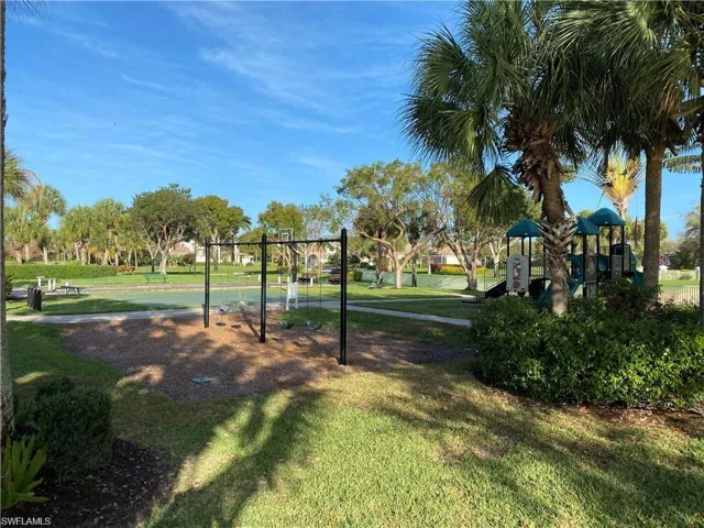 Surrounding community featuring a playground and a lawn