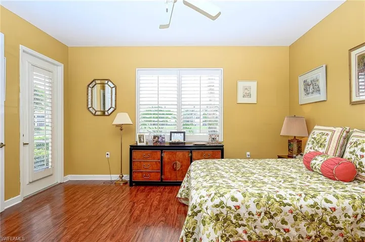 Bedroom with access to outside, multiple windows, and ceiling fan