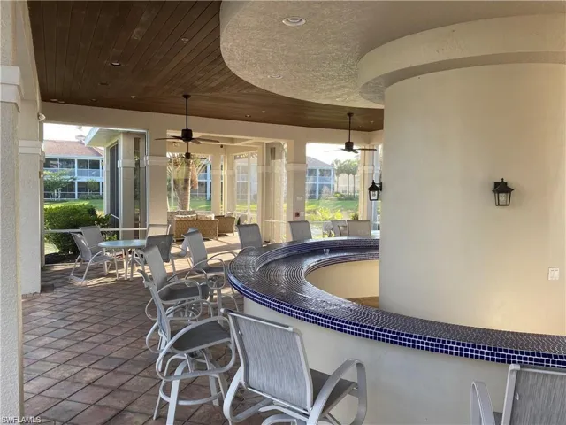 View of patio / terrace with ceiling fan and an outdoor bar