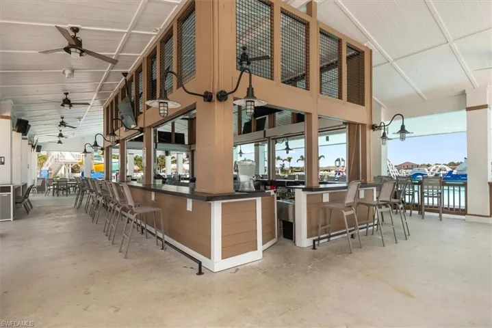 View of patio / terrace featuring outdoor dry bar and ceiling fan
