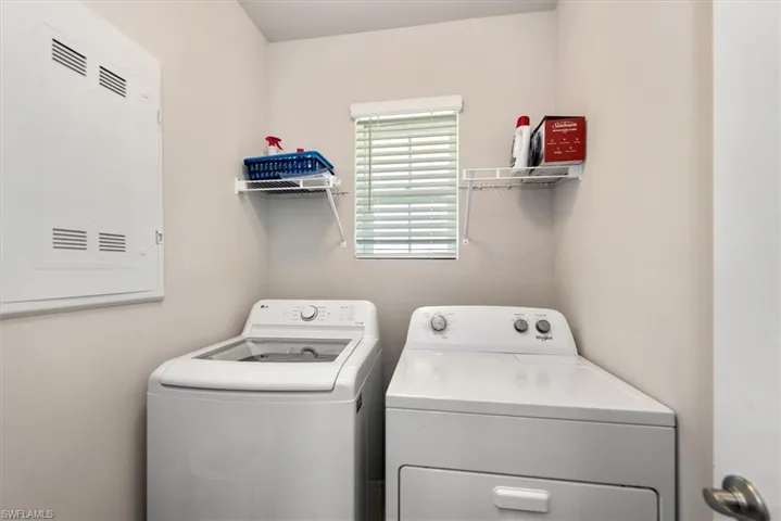 Clothes washing area featuring independent washer and dryer and laundry area