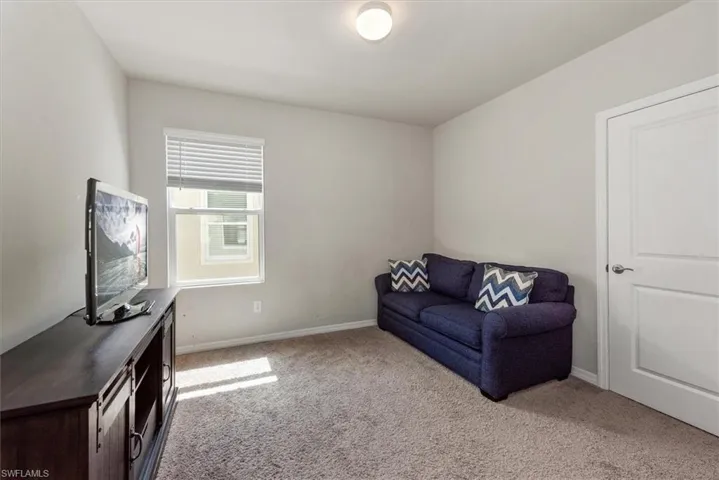 Living area with baseboards and carpet floors
