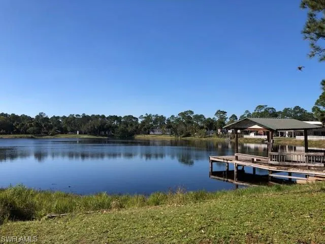 View of dock featuring a gazebo and a water view