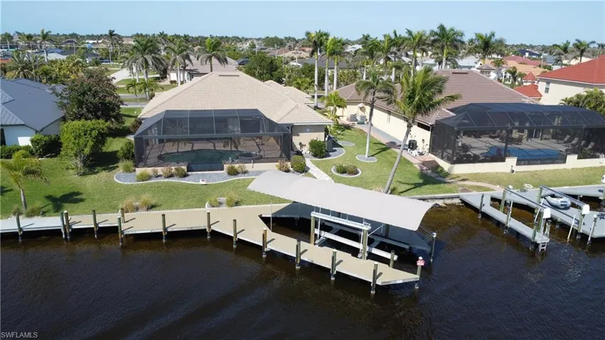 Birds eye view of property with a residential view and a water view