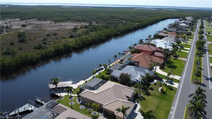Drone / aerial view featuring a residential view, a water view, and a wooded view